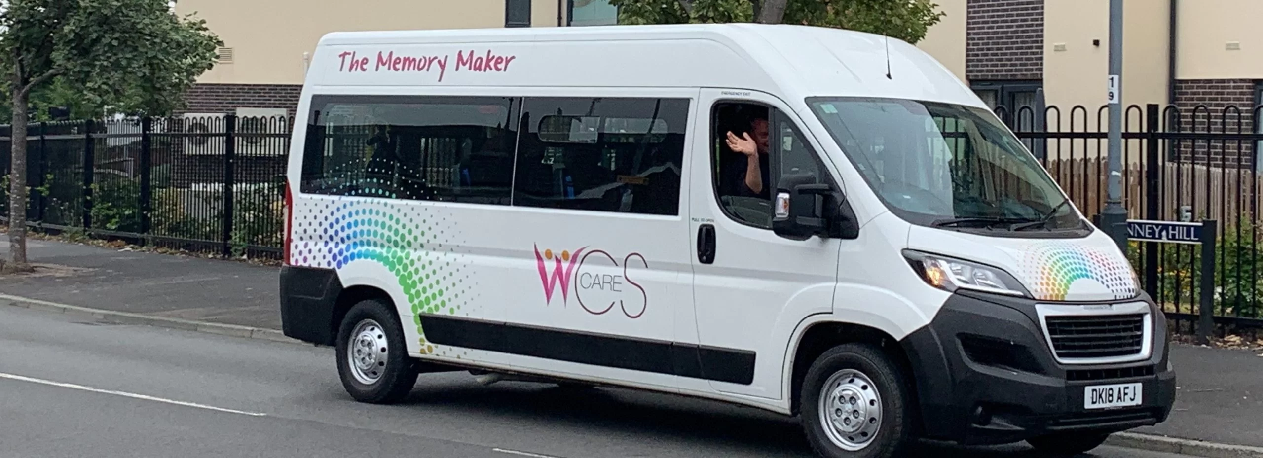 Ed-waving-in-minibus-Woodside-Care-Village-cropped-3-scaled